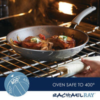 Pork chops sizzle in a Cook + Create Nonstick Frying Pan inside an oven, which is labeled as safe up to 400 degrees.