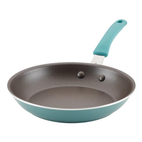 The Cook + Create Nonstick Frying Pan features a high-performance nonstick surface and a teal handle, constructed from thicker gauge aluminum and displayed on a pristine white background.