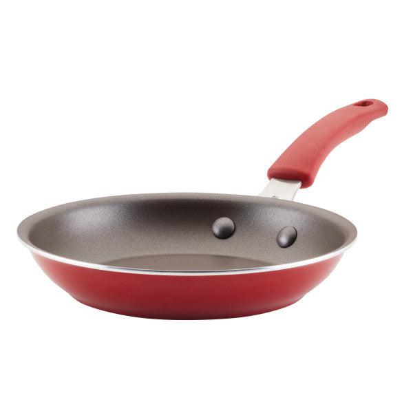 Introducing the Cook + Create Nonstick Frying Pan, designed for high performance with thicker gauge aluminum, a black non-stick interior, and a coordinating red handle.