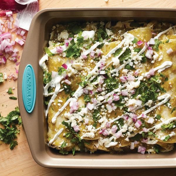 A baking dish of enchiladas topped with cheese, onions, and cilantro becomes even more delightful when prepared in the 2-Piece 9-Inch Nonstick Square Cake Pans.