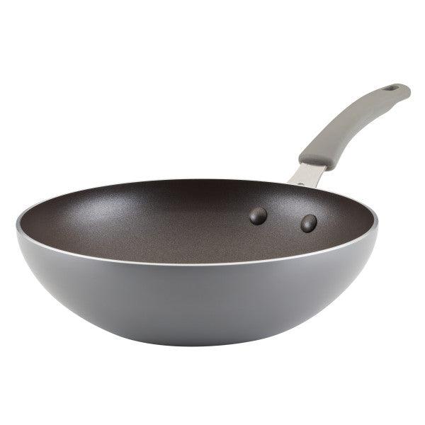 The 10.5-Inch Cook + Create Nonstick Open Stir Fry pan comes in gray aluminum and is equipped with a curved handle and a nonstick surface.