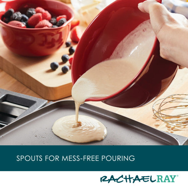 The 2-Piece Ceramic Mixing Bowl Set is used to pour batter onto a griddle, with berries in the background.