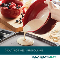 The 2-Piece Ceramic Mixing Bowl Set is used to pour batter onto a griddle, with berries in the background.