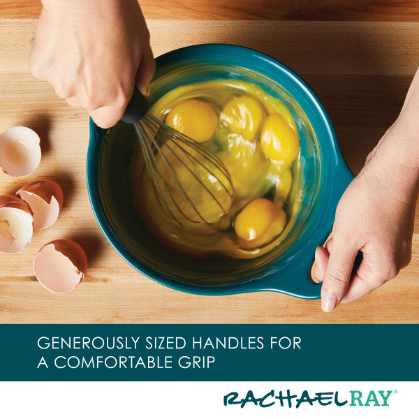 Using a 2-Piece Ceramic Mixing Bowl Set to whisk eggs, with egg shells nearby on a wooden surface, makes cleanup easy since the bowls are dishwasher safe.