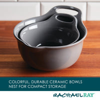 On a wooden counter with a kitchen tile background, the 2-Piece Ceramic Mixing Bowl Set is stacked, showcasing its versatile design and dishwasher-safe quality.