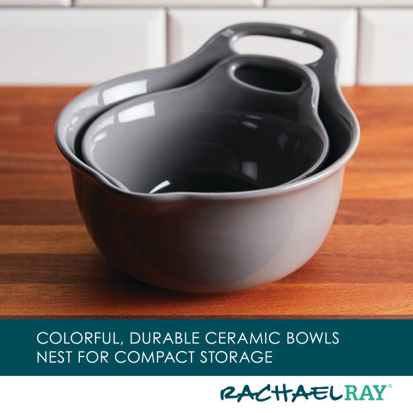 On a wooden counter with a kitchen tile background, the 2-Piece Ceramic Mixing Bowl Set is stacked, showcasing its versatile design and dishwasher-safe quality.