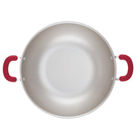 Top view of a 14.25-inch nonstick induction wok with red handles.