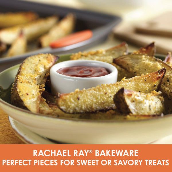 Potato wedges on a plate with a small bowl of sauce, perfectly crisped in a heavy gauge steel pan from your 5-Piece Nonstick Bakeware Set.