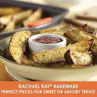 Potato wedges on a plate with a small bowl of sauce, perfectly crisped in a heavy gauge steel pan from your 5-Piece Nonstick Bakeware Set.