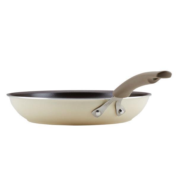 The Cook + Create Nonstick Frying Pan is a high-performance kitchen tool in cream with a beige handle, crafted from thicker gauge aluminum for enhanced durability. Its nonstick surface guarantees effortless cooking and easy cleanup.