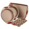Introducing the 4-Piece Nonstick Bakeware Set, featuring cake pans, a sheet pan, and a muffin tin with red handles. Crafted from heavy gauge steel, this oven-safe collection guarantees perfect results every time.