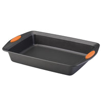 Black baking pan with orange handles on a white background.
