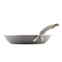 Gray Cook + Create Nonstick Frying Pan, made from thicker gauge aluminum with an ergonomic handle, shown from the side.