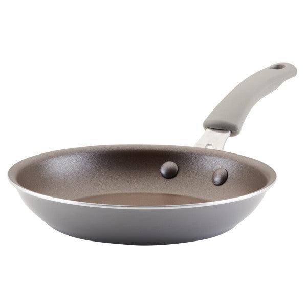 Cook + Create Nonstick Frying Pan featuring a gray handle and durable metal rivets for high performance.