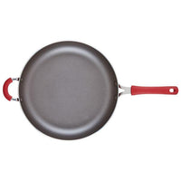The Cook + Create Nonstick Frying Pan features a high-performance design, boasting a durable non-stick gray surface and a vibrant red handle, expertly crafted from thicker gauge aluminum.