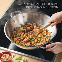 Stir-frying chicken in a 14-Inch Stainless Steel Induction Wok.