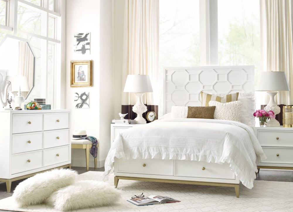 Bright bedroom with white furniture, fluffy rug, and decorative pillows.
