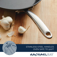 11-Piece Professional Hard-Anodized Nonstick and Induction Stainless Steel Cookware Set with a stainless steel handle beside garlic on a wooden surface, perfect for any kitchen that values quality nonstick cookware.
