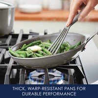 Cooking green beans with butter in a skillet on a gas stove.