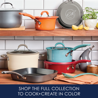Colorful cookware set displayed on wooden shelves in a kitchen setting.