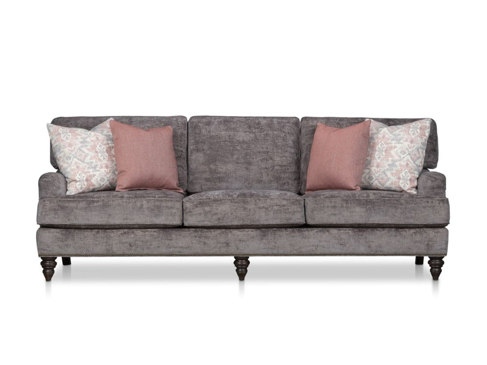 Gray sofa with four decorative pillows on a white background.