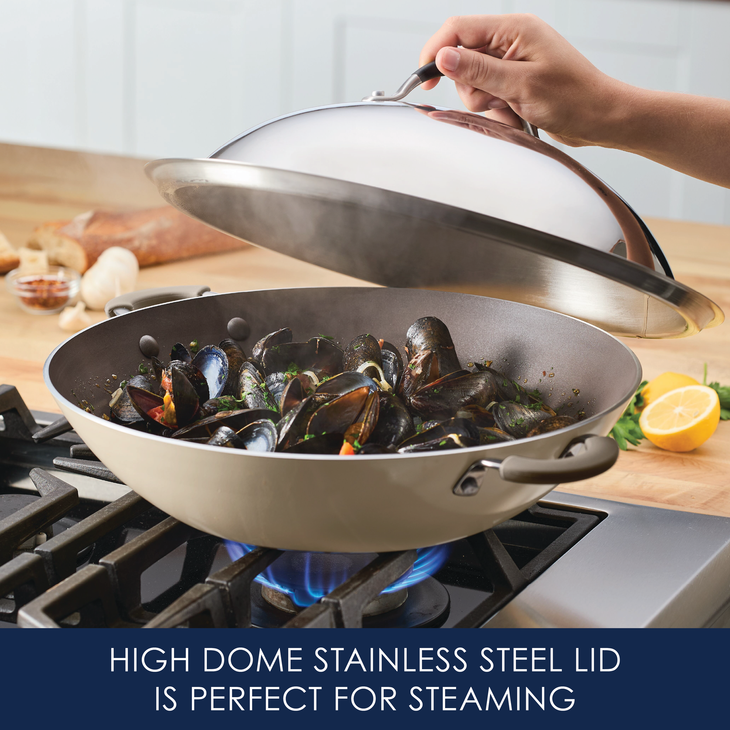A person lifts the 14-Inch Stainless Steel Domed Lid from a pot of steaming mussels.