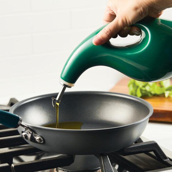 By using the 24-ounce EVOO Bottle equipped with a stainless steel pour spout, you can achieve precision pouring as the golden oil streams gracefully into the frying pan on the stove.