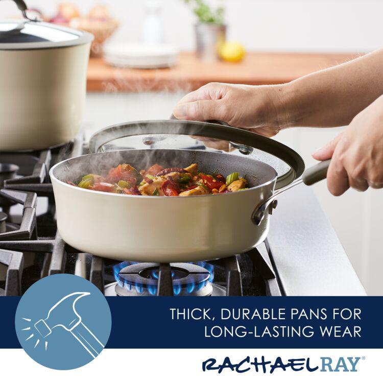 A person is expertly sautéing vegetables in a 3-Quart Cook + Create Nonstick Sauté Pan with Lid on the stove, with steam rising gracefully.