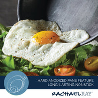 A fried egg rests atop a fresh salad, elegantly served from the 11-Piece Professional Hard-Anodized Nonstick and Induction Stainless Steel Cookware Set.
