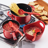 The red cookware set with pasta, sauce, and meat mixture on a stove provides versatility when paired perfectly with the 3-Piece Lazy Tool Set of nylon cooking utensils that are heat safe.