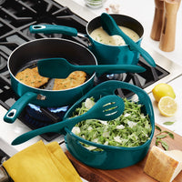 The cookware set features pans, soup, and salad on a stovetop, accompanied by the versatile 3-Piece Lazy Tool Set.