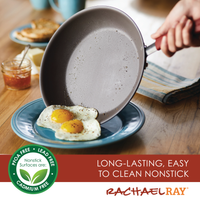 A person is serving fried eggs from an espresso-colored pan from the 10-Piece Cucina Nonstick Cookware Set onto a blue plate, showcasing rubberized stainless steel handles for a comfortable grip.