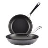 The 2-Piece Cook + Create Hard Anodized Nonstick Frying Pan Set includes two black frying pans crafted from hard-anodized aluminum, featuring metal handles and designed to nest together for convenience.