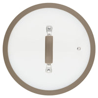 A glass lid, featuring a beige handle and rim, seen from above, is designed to complement the 3-Quart Cook + Create Nonstick Sauté Pan with Lid.