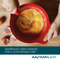 Using the 2-Qt. & 3-Qt. Nesting Mixing Bowl Set with a vibrant red hue and a non-slip rubberized bottom, I whisk eggs while broken eggshells lay scattered nearby.