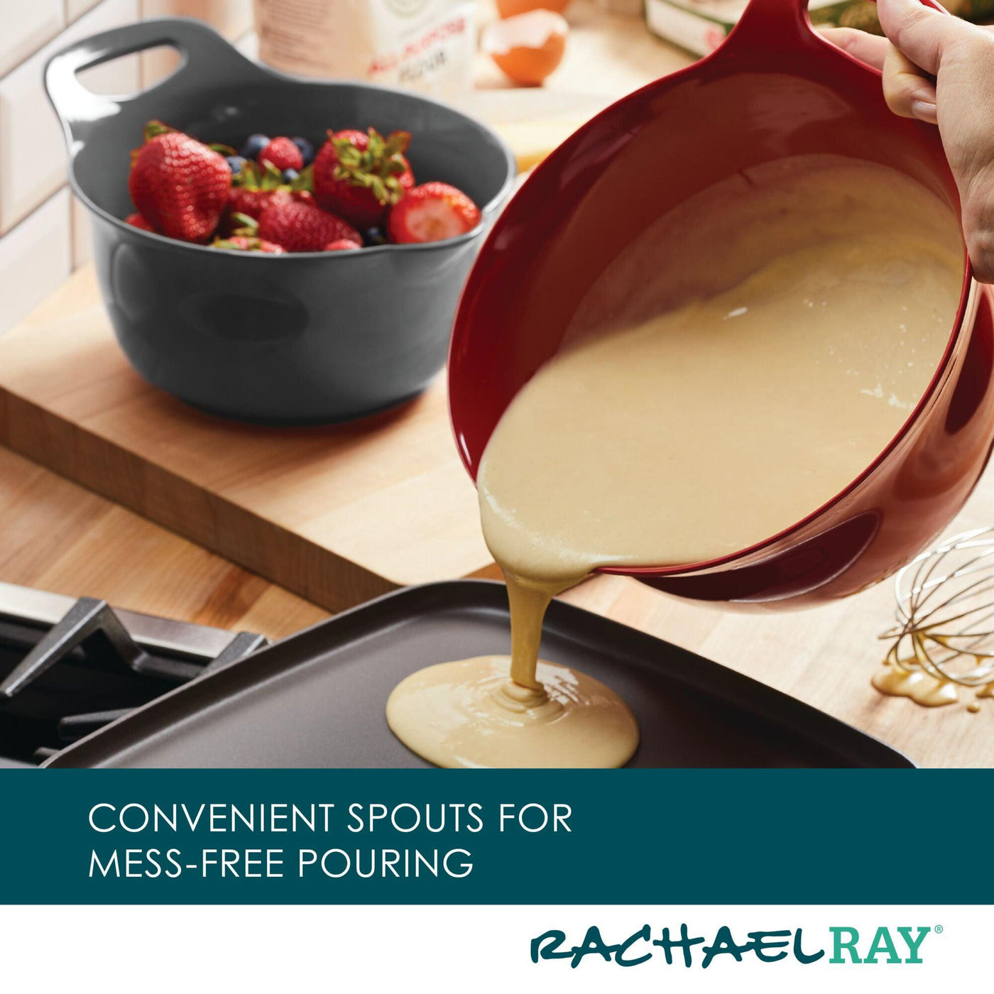 A stylish mixing bowl from the 2-Qt. & 3-Qt. Nesting Mixing Bowl Set, featuring a non-slip rubberized bottom, allows for easy batter pouring through its convenient spout onto the cooking surface.