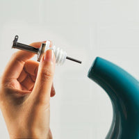 A hand inserting a stainless steel pour spout into the 24-Ounce EVOO Bottle, ensuring precision pouring with every use.