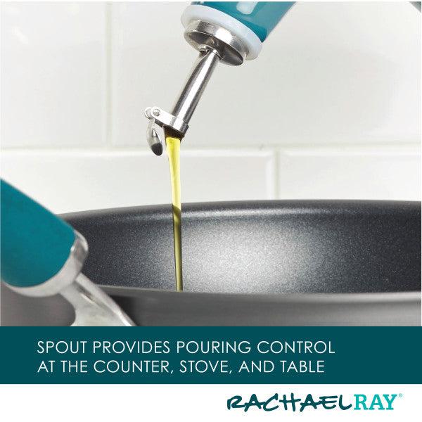 Oil flows into the pan from a stainless steel pour spout with blue handles, providing precise pouring from the 24-Ounce EVOO Bottle.