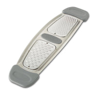 Introducing the Stainless Steel Multi-Grater, a gray and white kitchen essential featuring dual grating surfaces perfect for citrus zest, equipped with durable rubber ends and optional silicone handles.